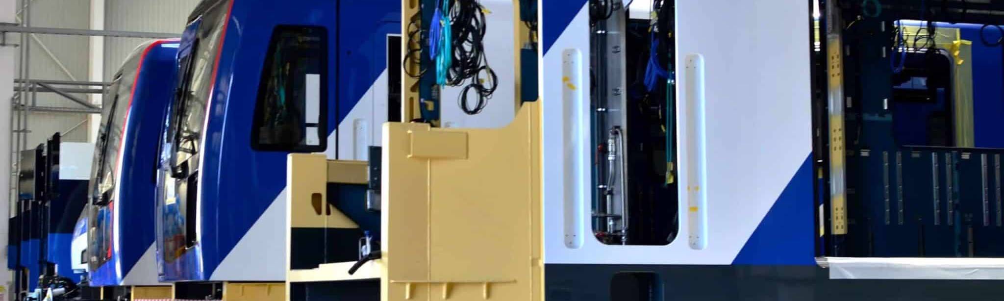 Railcars being assembled in a workshop, ready to be fitted with RFID tags compliant with the GS1 ID Rail standard.