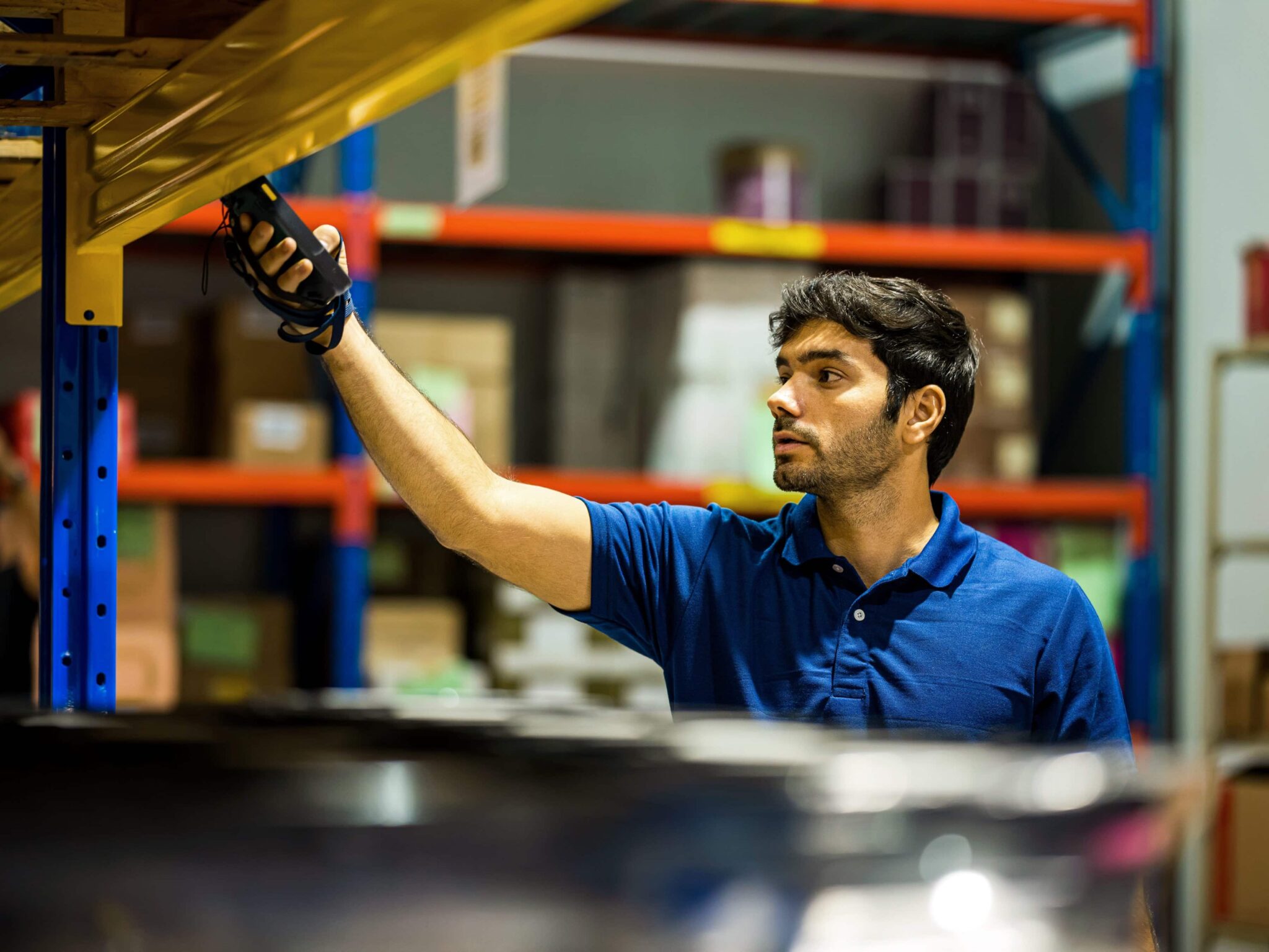 An operator checking items on a shelf during a physical inventory in a warehouse
