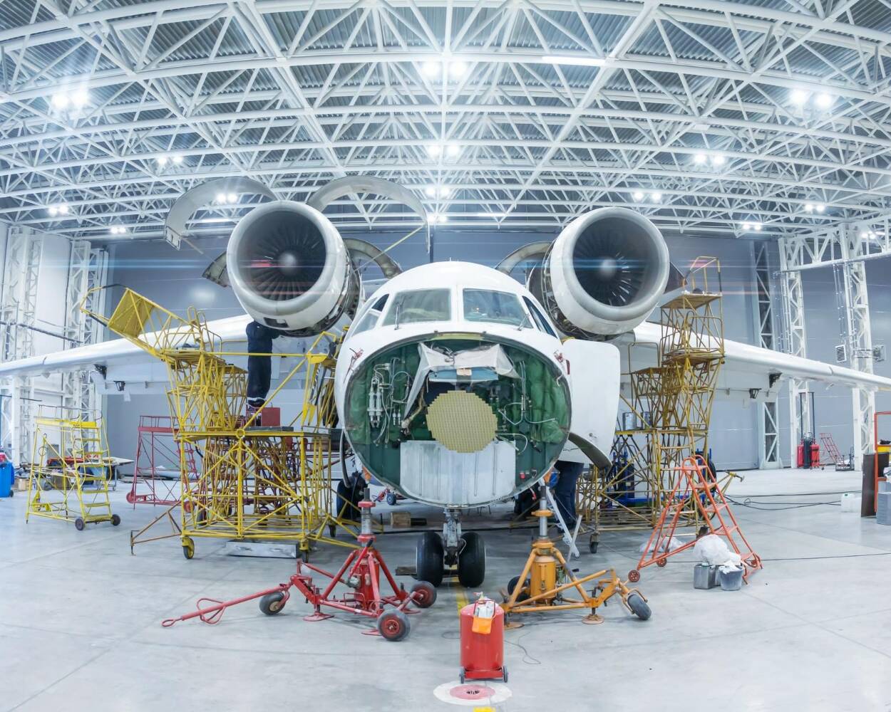 Aircraft undergoing maintenance in an aircraft hangar illustrating parts traceability with ATA Spec 2000