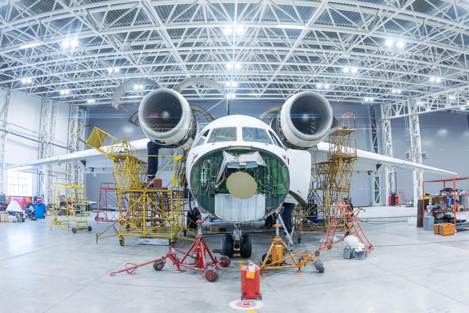 Aircraft undergoing maintenance in an aircraft hangar illustrating parts traceability with ATA Spec 2000